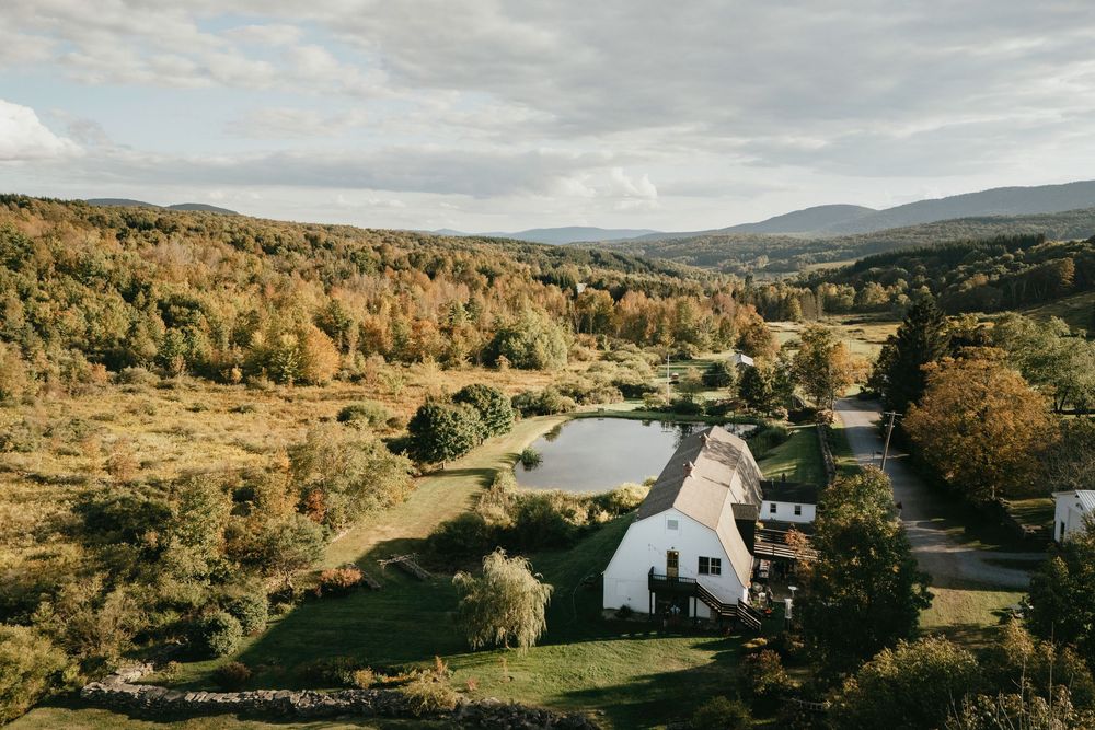 Rolling hills and scenic countryside landscapes with autumn trees and a small pond reflecting cloudy skies.