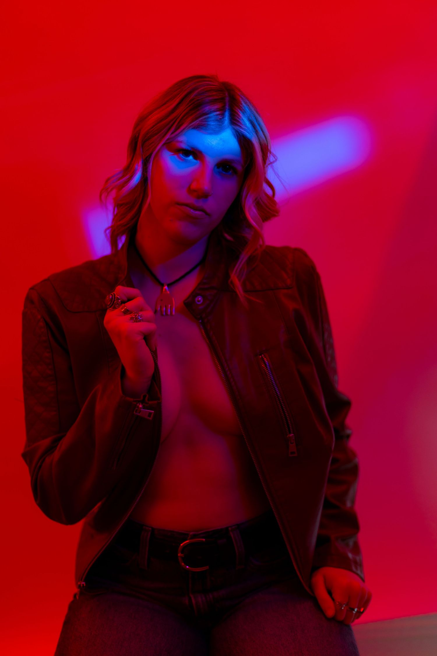 Artistic portrait series with red and blue lighting shows a person in a jacket posing dramatically against dark background.