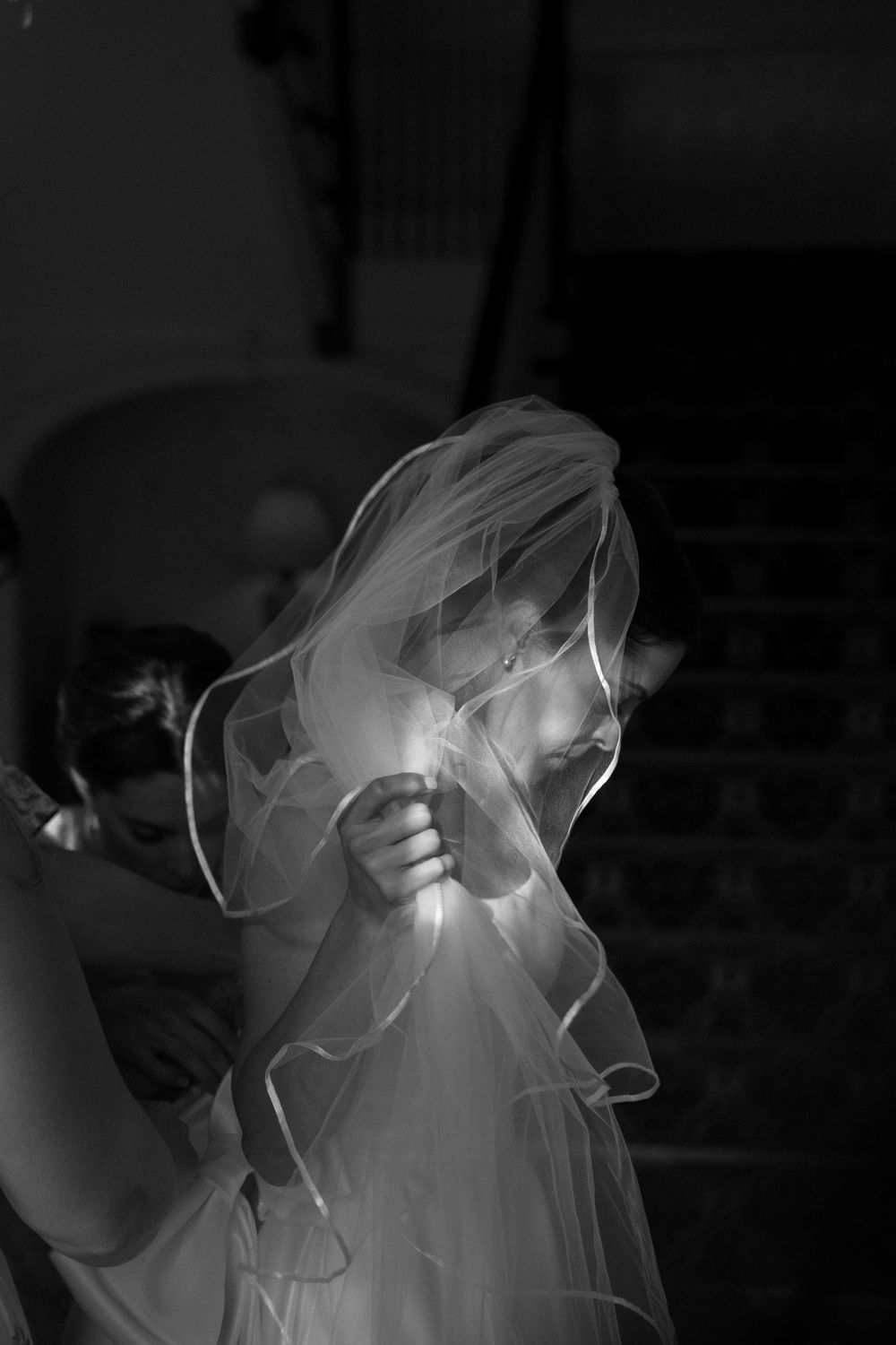 Ethereal movement of wedding veils captured in dramatic black and white photography.