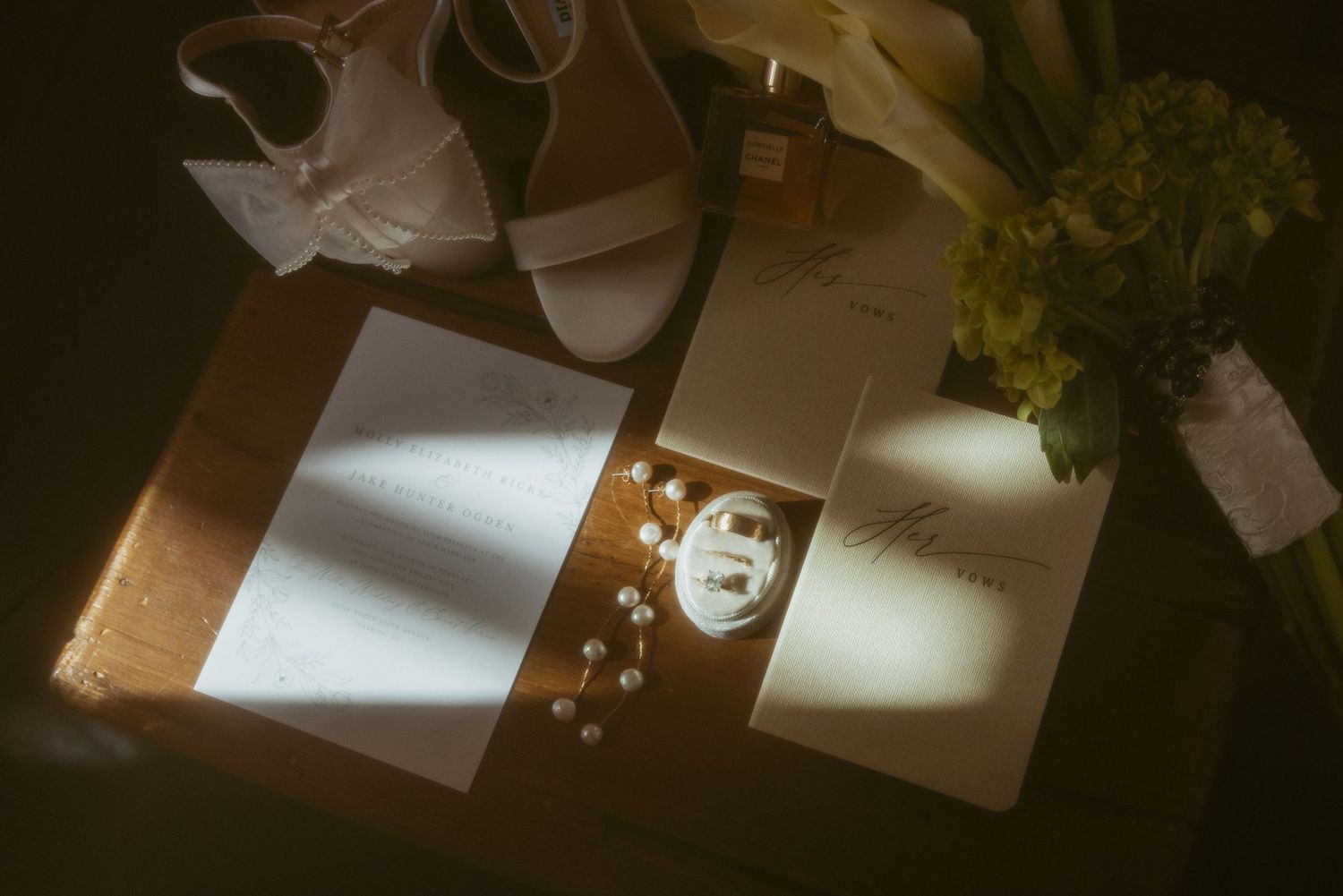 Scattered papers and documents lying on a wooden surface illuminated by soft lighting.