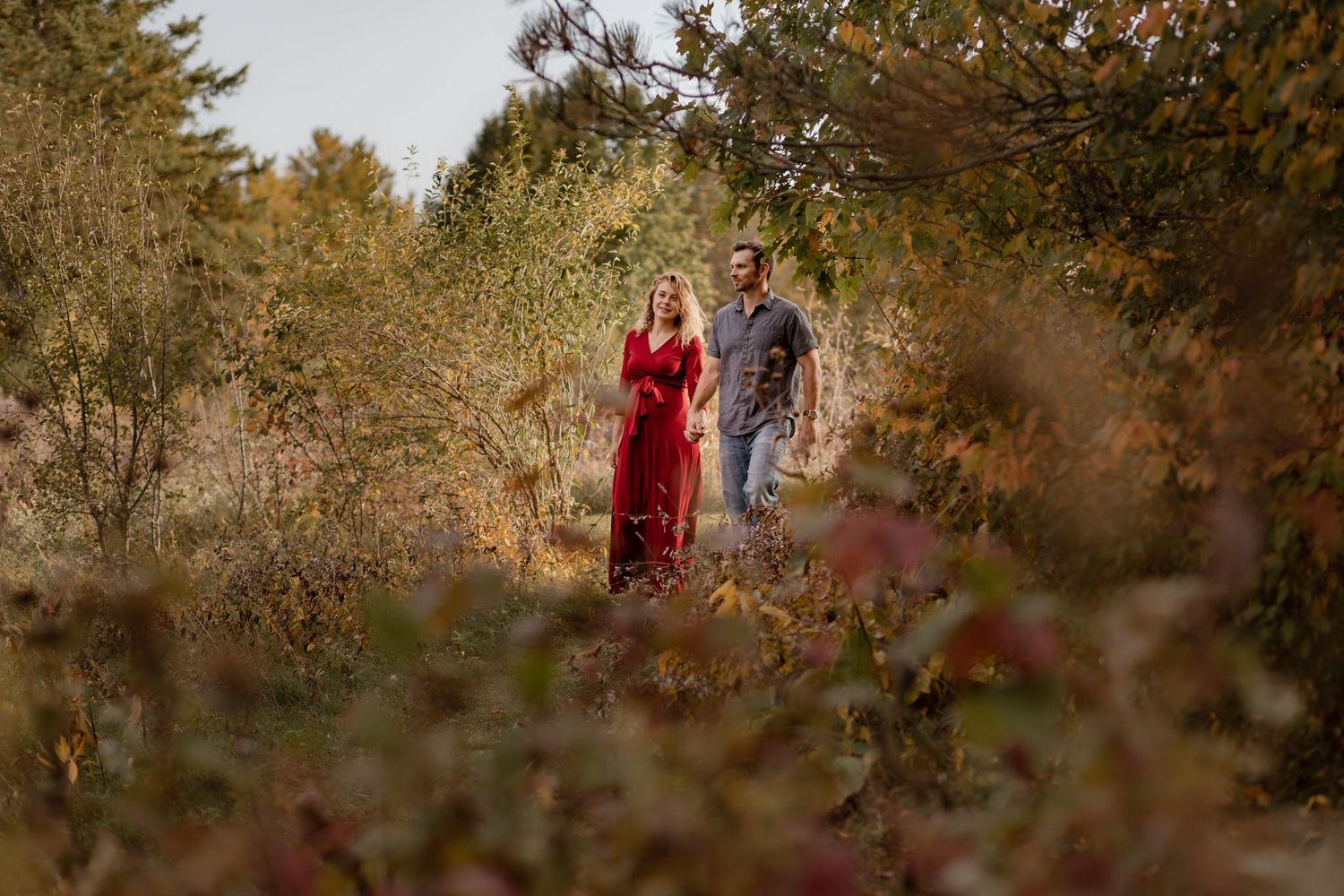 couple walk through fall foliage at cataraqui creek conservation area