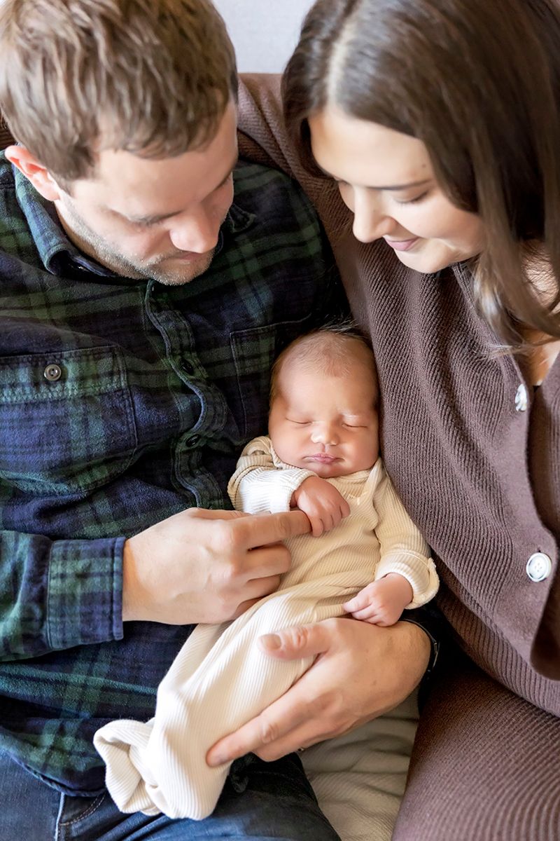 A sequence of photos showing a baby being fed from a bottle while being cradled.