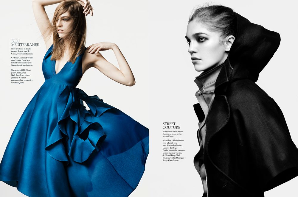 Fashion editorial featuring dramatic contrast between black and bright blue sculptural garments against white backdrop.