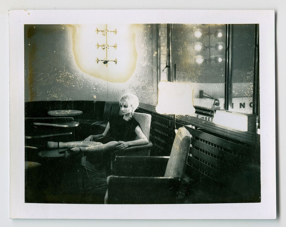 A series of vintage black and white photographs showing a person working at a desk in dim lighting conditions.