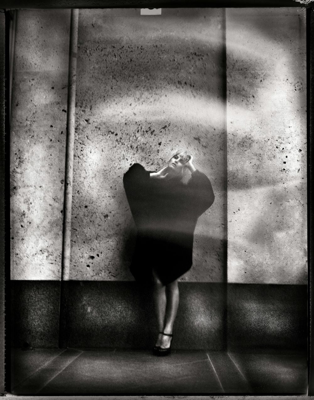 A dark and moody black and white triptych showing a silhouetted figure against a textured wall with dramatic lighting.