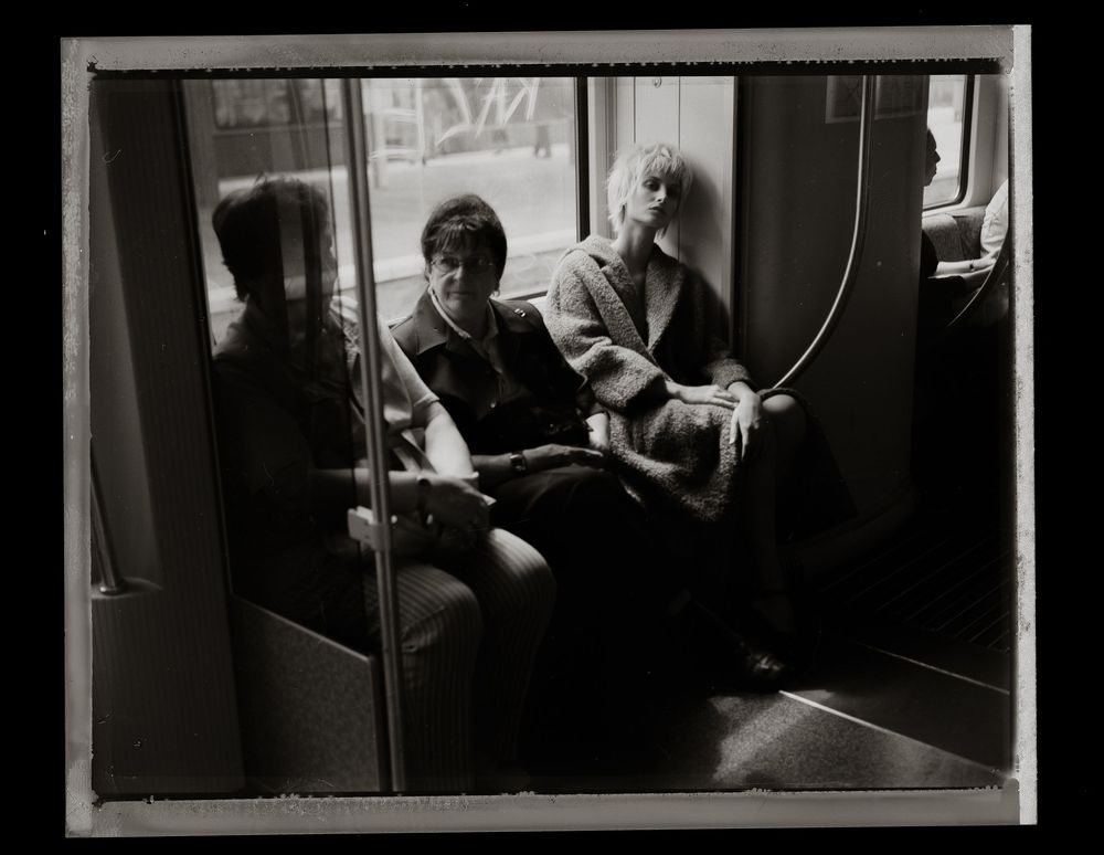 Series of black and white photographs showing interior scenes of public transit or subway cars.