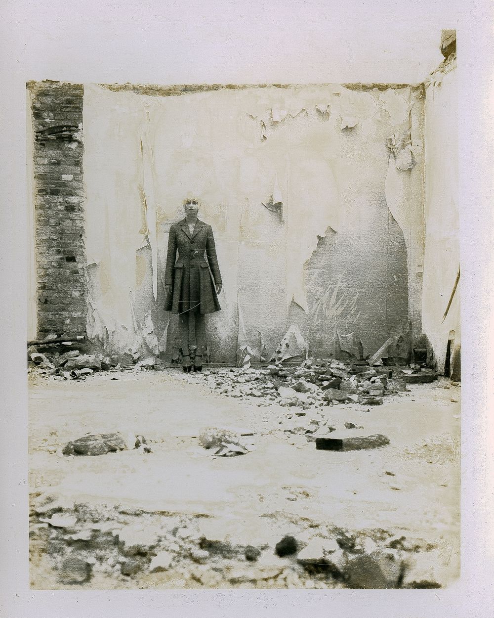 A series of vintage black and white photographs showing a person standing against a damaged wall in different poses.