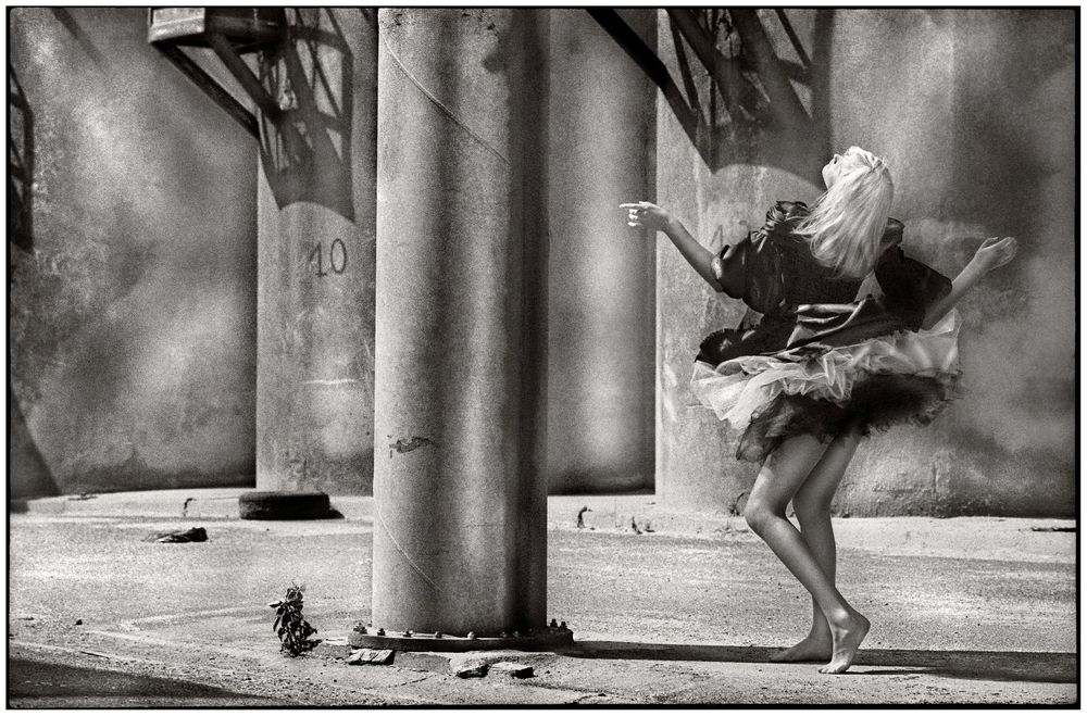 Ballet dancers' feet and legs perform graceful movements in a black and white photo series.