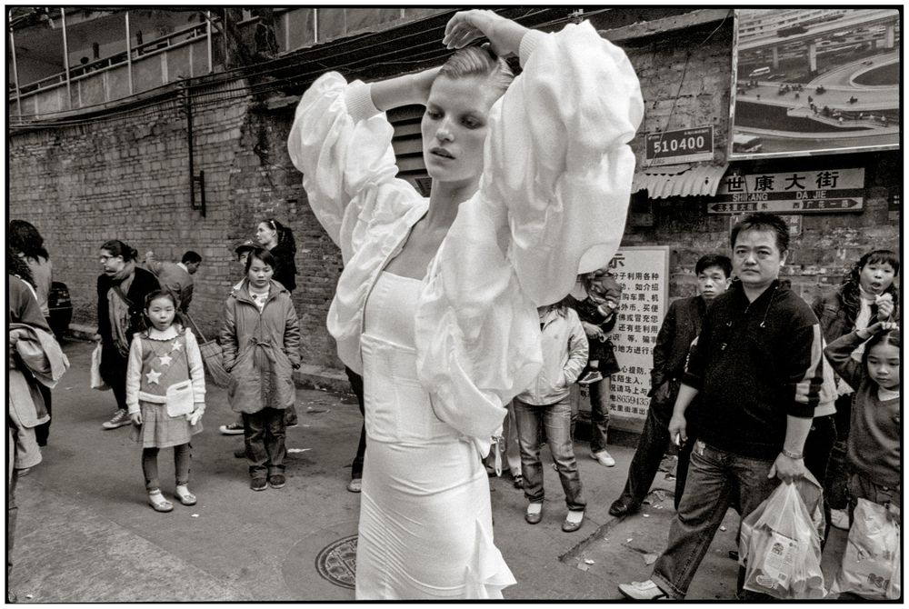 A black and white photo series showing people dancing and celebrating at what appears to be a festive street gathering.