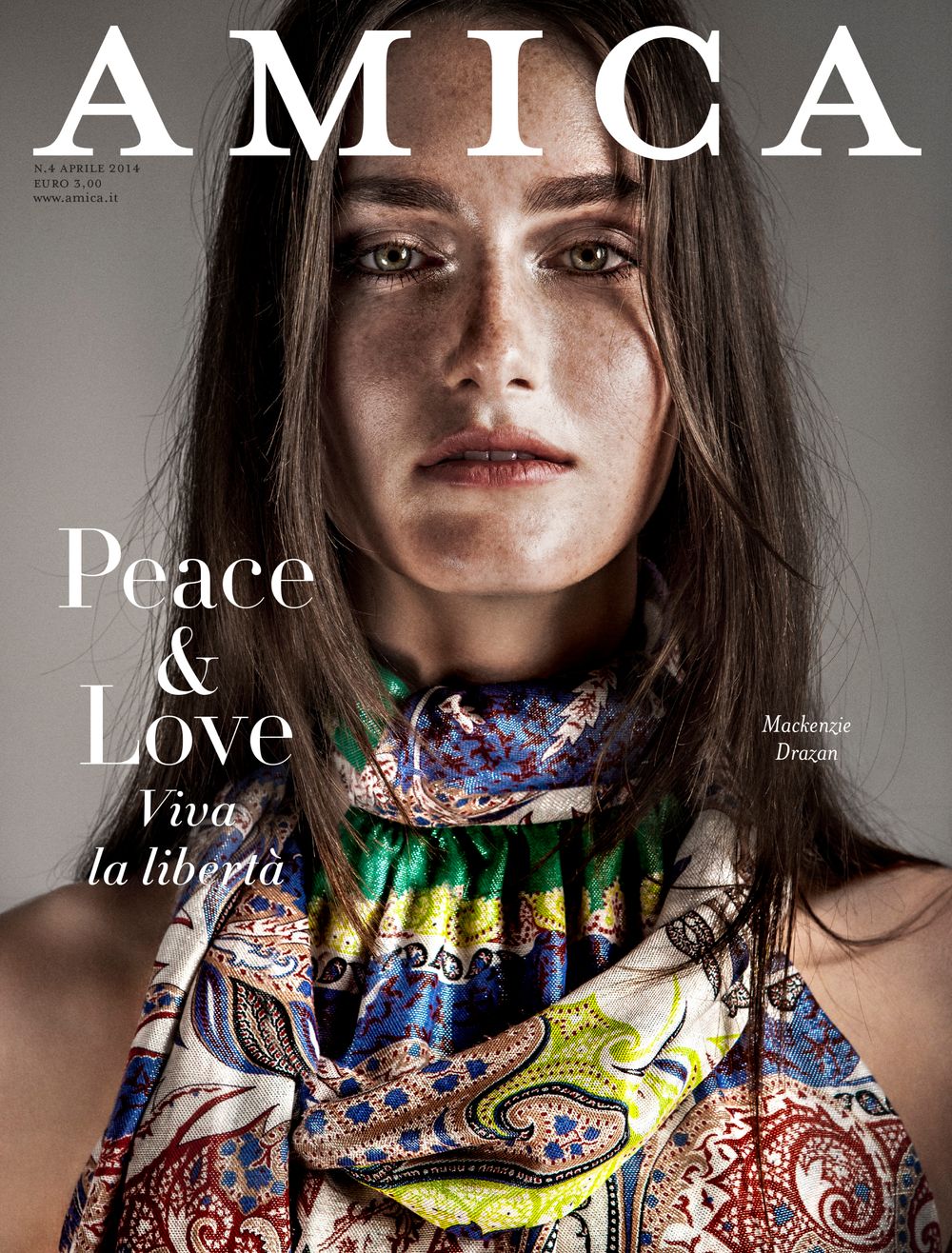 Fashion editorial spread showing colorful ethnic print necklaces and jewelry against dark studio backdrop.