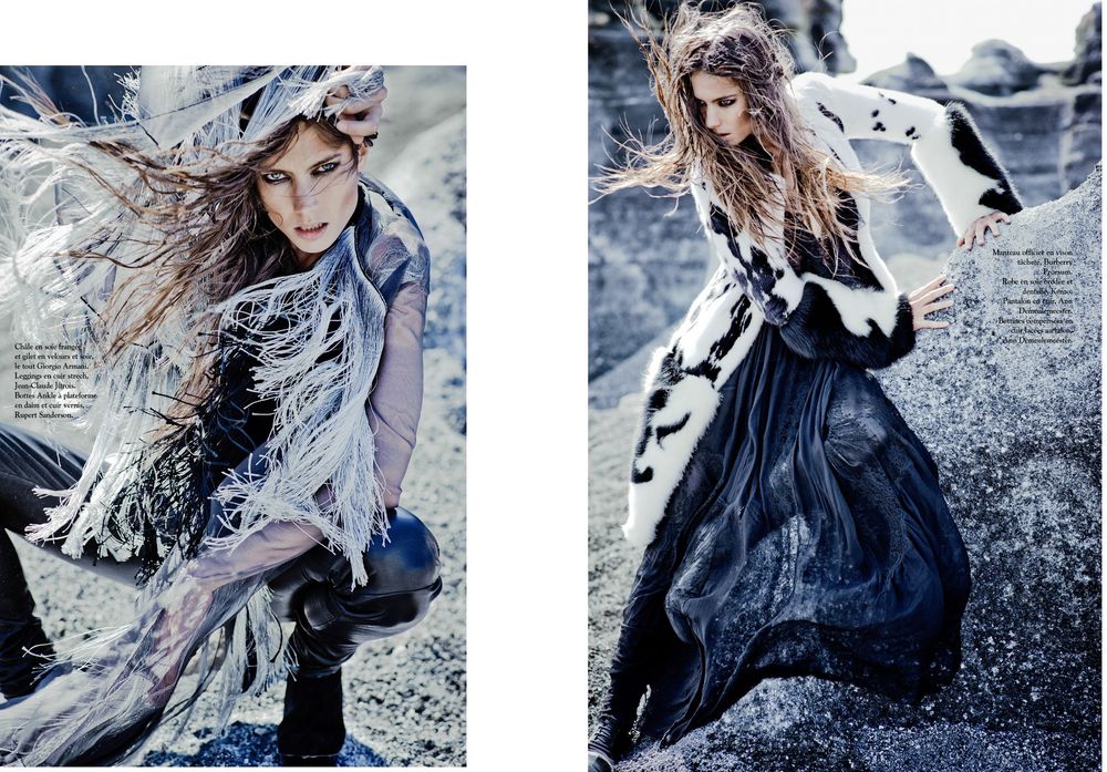 Fashion editorial photos in blue tones showing flowing dress and hair movement against rocky outdoor backdrop.