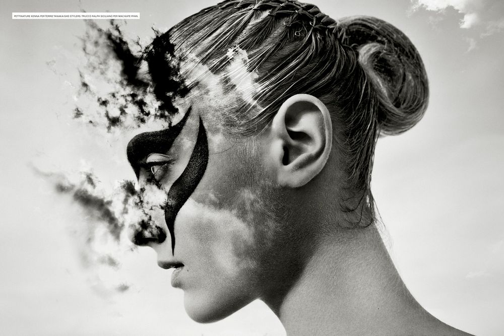 Artistic black and white portrait showing smoke dissolving into a person's profile silhouette against a light background.