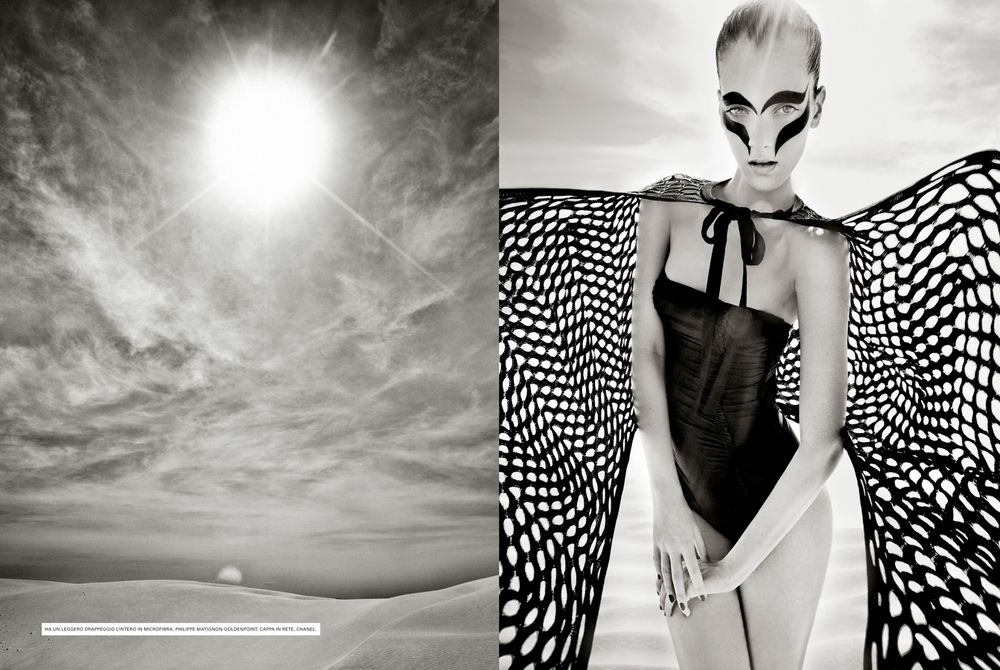 Black and white checkered dress pattern creates dramatic contrast against sunlit sky in artistic fashion photograph.