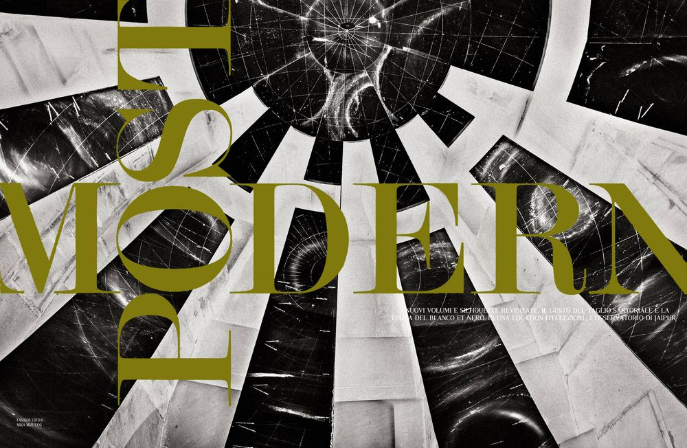 A black and white abstract geometric pattern with yellow accents creates a dynamic fragmented design.