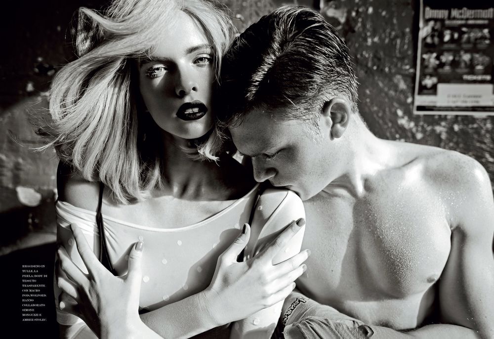 Dramatic black and white fashion photoshoot featuring intimate poses in retro diner setting.