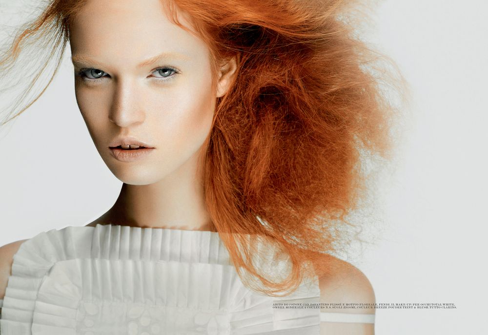 High fashion beauty shots highlighting pale ruffled garments and striking copper-toned hair styling.