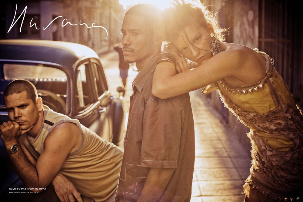 Silhouetted figures dance intimately in warm golden lighting during a romantic moment on a dance floor.