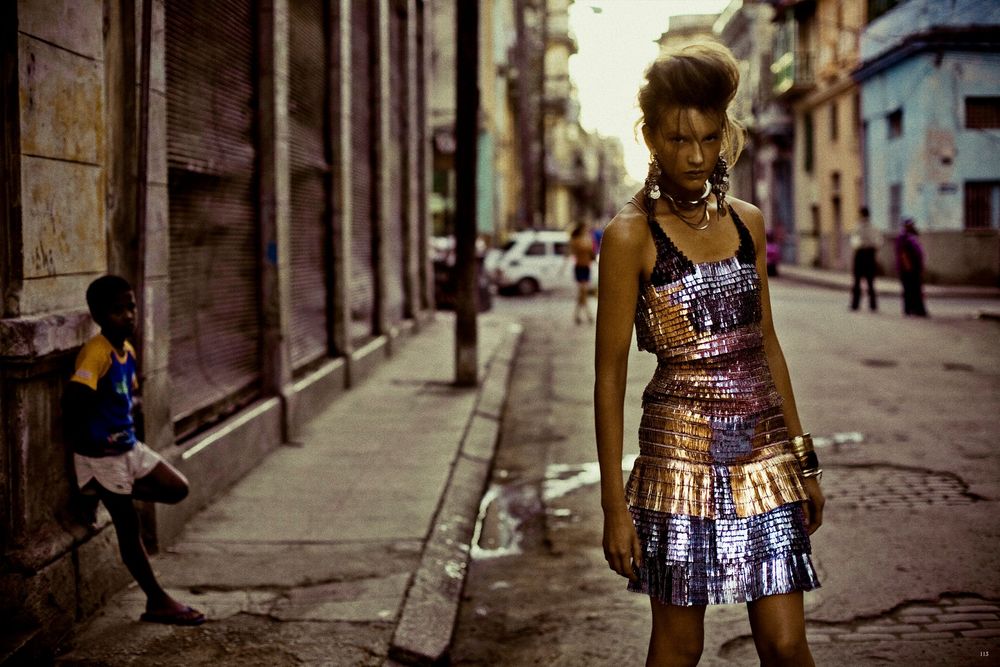 A series of vintage-style photos showing someone walking down a cobblestone street in a metallic dress.