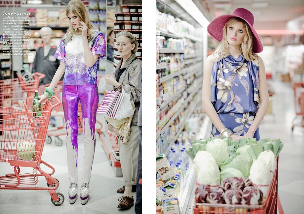 Shopping scene with person pushing red cart through store aisle while looking at products on shelves.