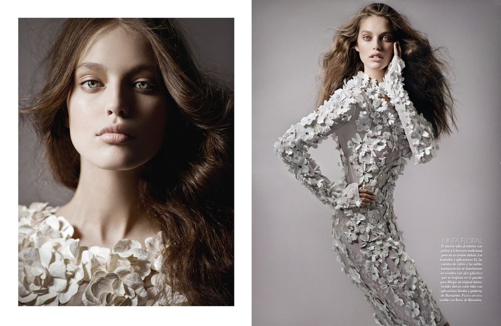A fashion editorial featuring delicate white floral lace garments photographed against a neutral grey backdrop.