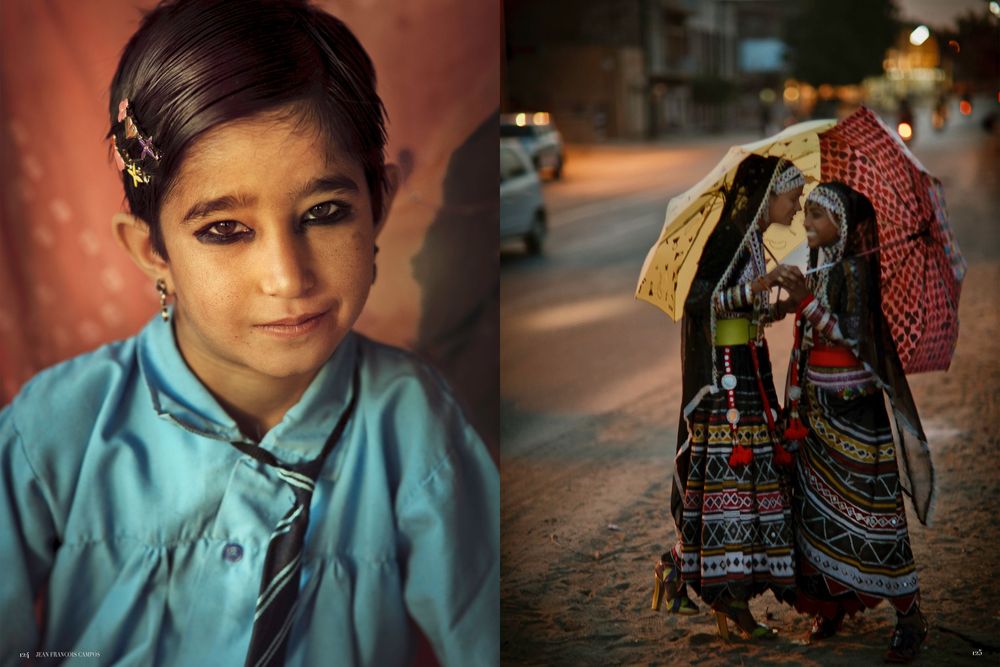 A child in a turquoise shirt sits on stone steps with traditional Middle Eastern architecture visible in the background.