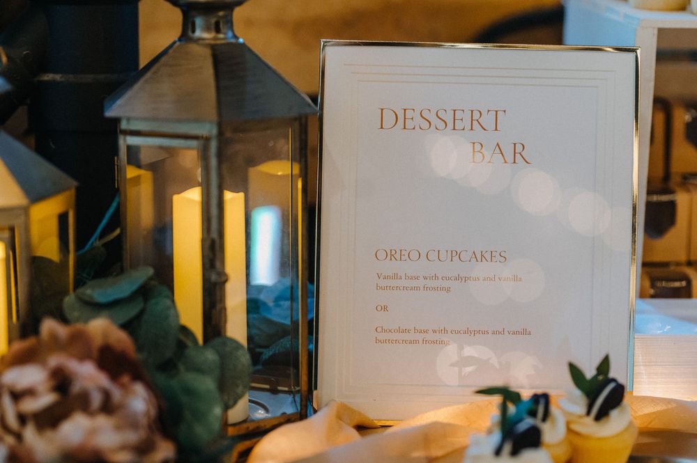Elegant dessert menu and bar signage displayed in a warmly lit restaurant interior.