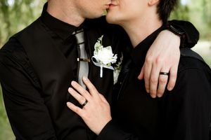 A romantic black and white wedding photo collage showing close-up details of hands, rings, and tender moments.