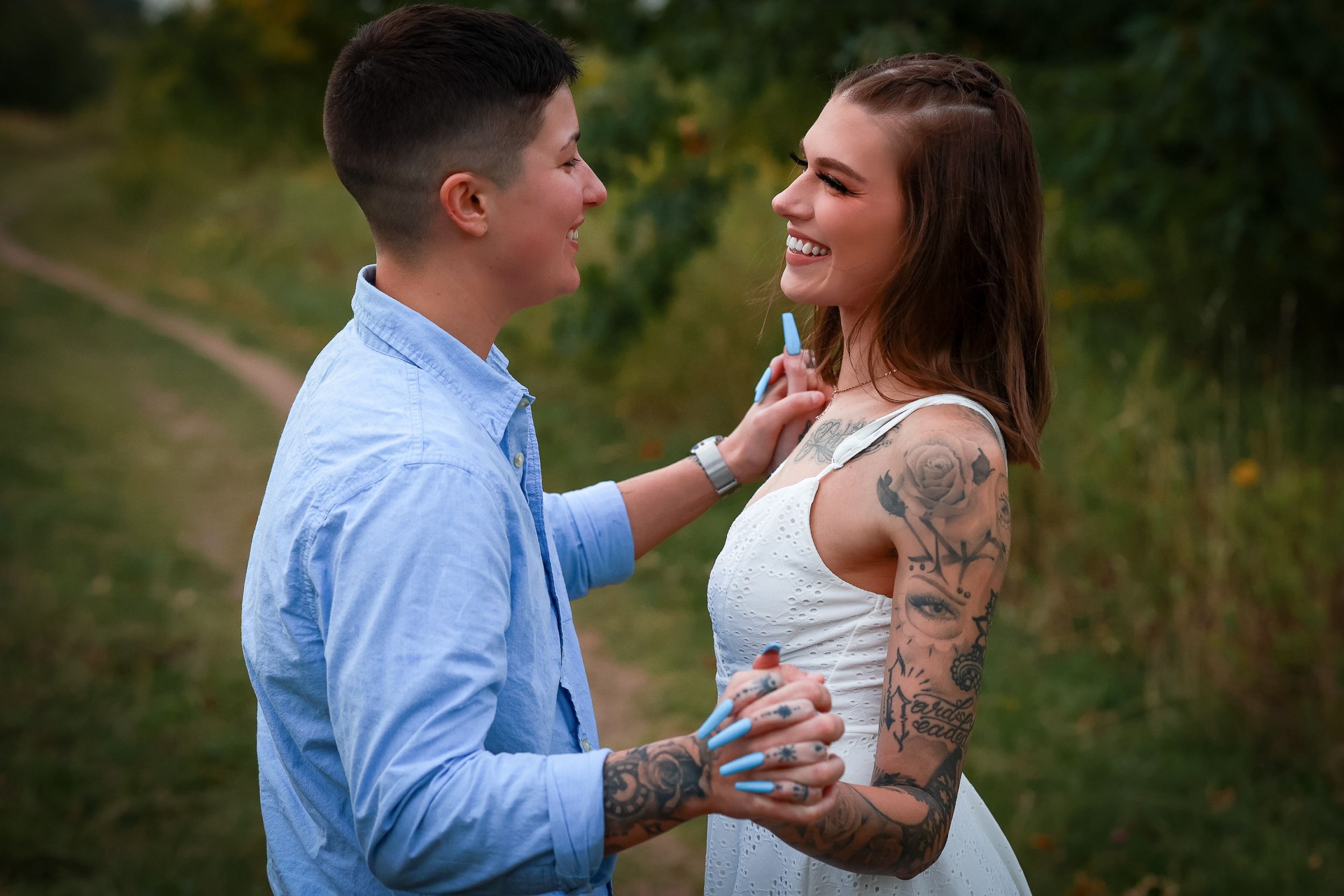 Engaged couple sharing an intimate moment outdoors in engagement attire.