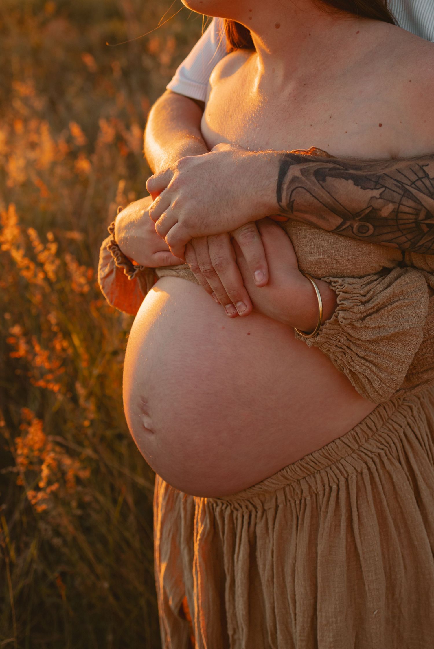 A maternity photo series shows a pregnant belly silhouetted against warm sunset lighting in a field.
