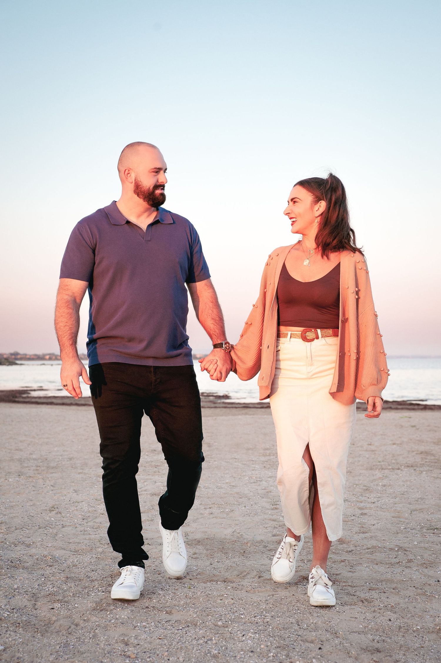 Candid shots of a couple walking and laughing together on a beach at sunset.
Altona Family Photographer Melbourne