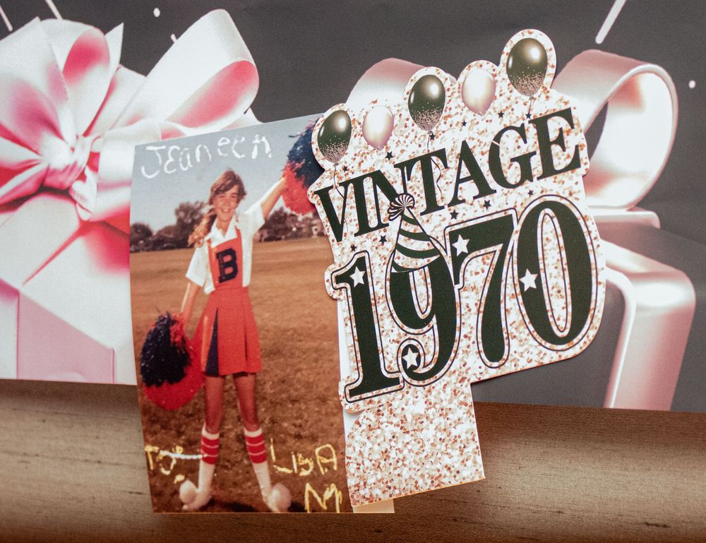 Paper image cutouts showing different vintage era text and style elements on a wooden surface.