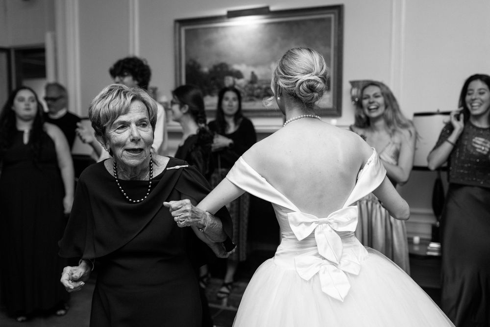 A collection of wedding moments showing two people dancing, hugging, and celebrating at an indoor venue.
