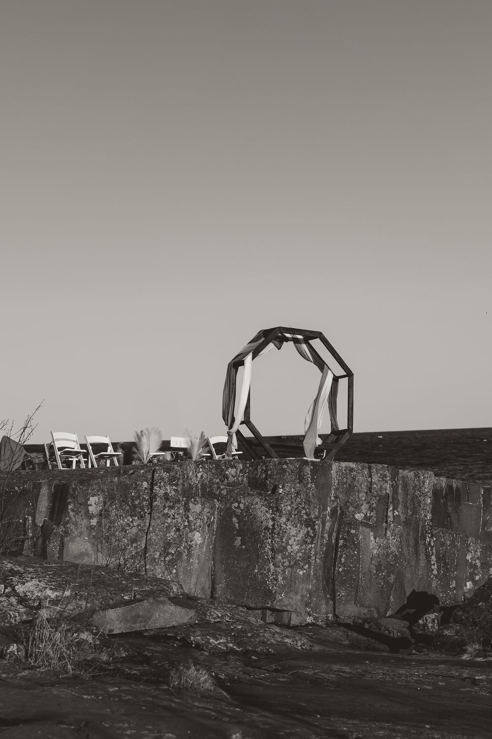 Stone wall ruins with mechanical equipment visible on the horizon against a dark sky.