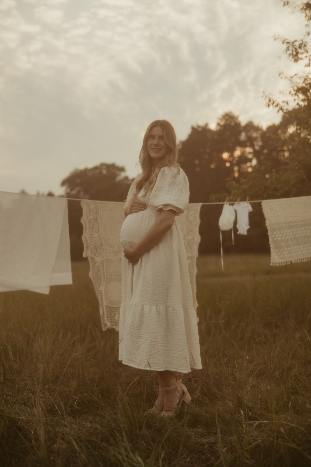 Five soft vintage-style photos show a clothesline with white linens hanging in a golden sunlit field at dusk Pine City Minnesota