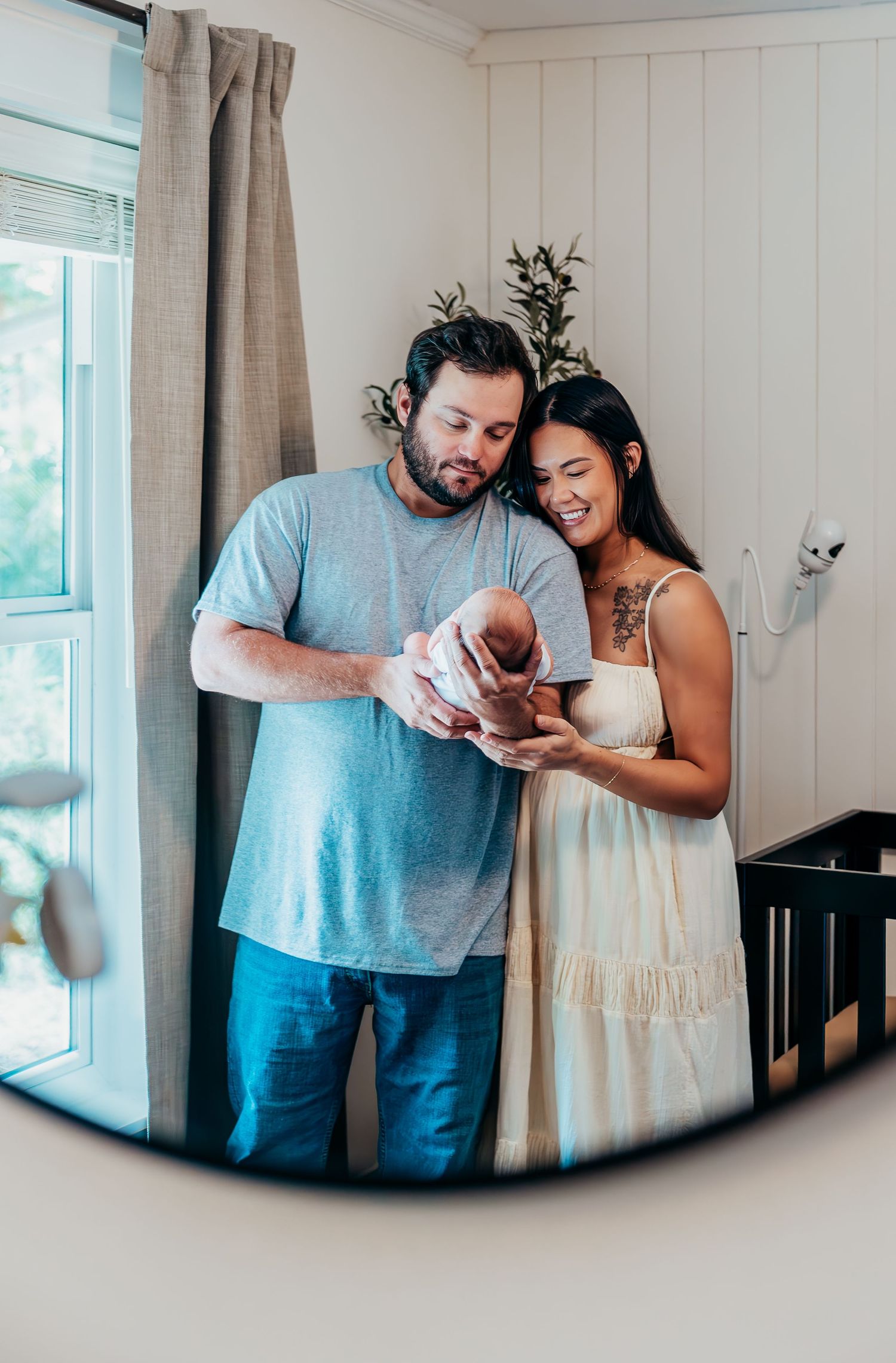 New family cuddling their newborn during in-home lifestyle session in Stuart Florida, newborn photographer in home session, treasure coast