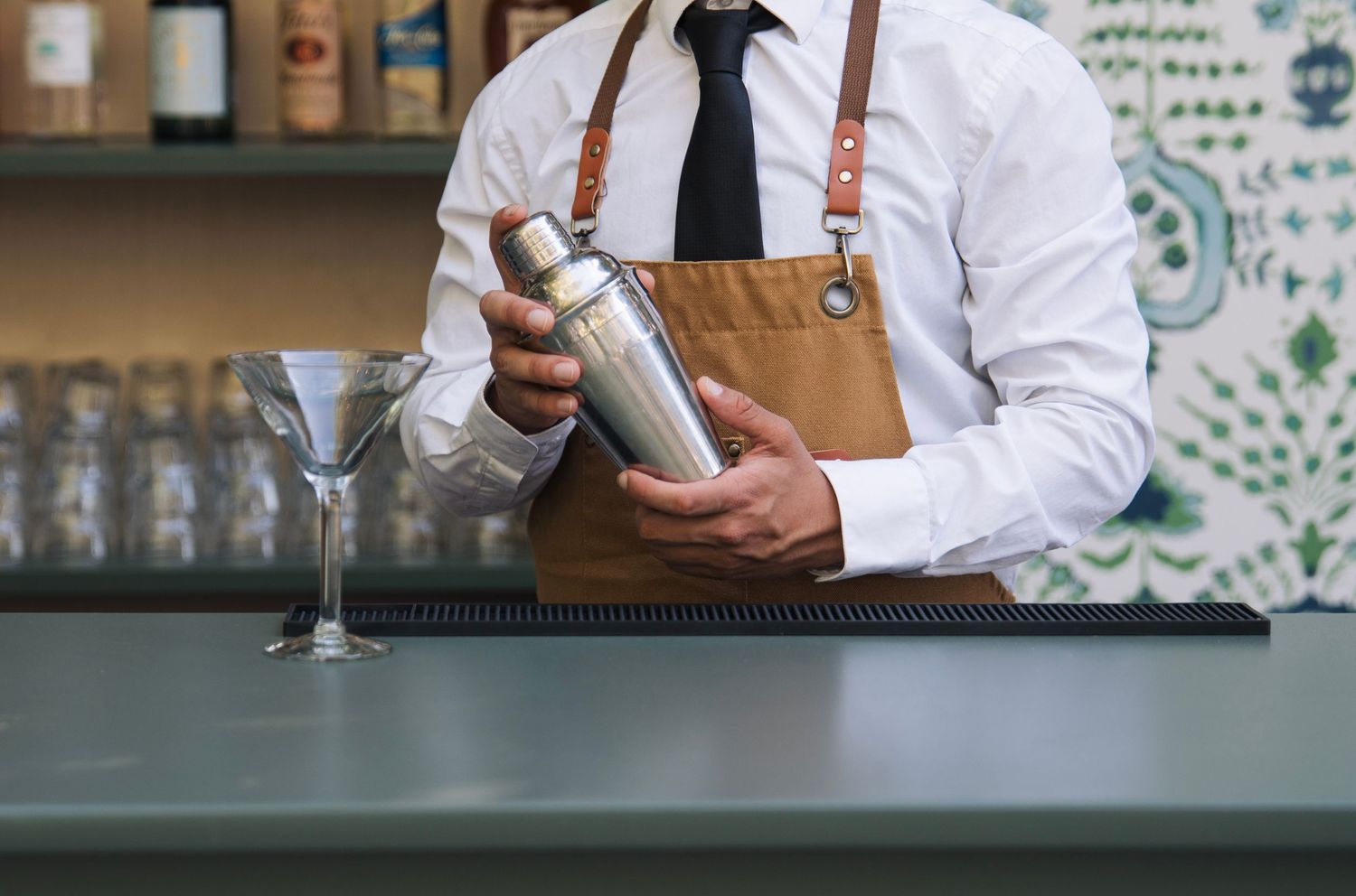 A man poses at the bar for a branding shot at the bar