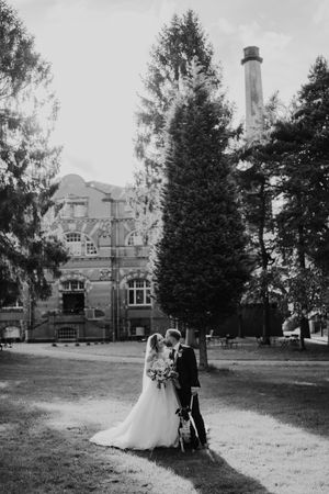 Black and white wedding photos show couple against historic mansion backdrop in romantic outdoor sequence.