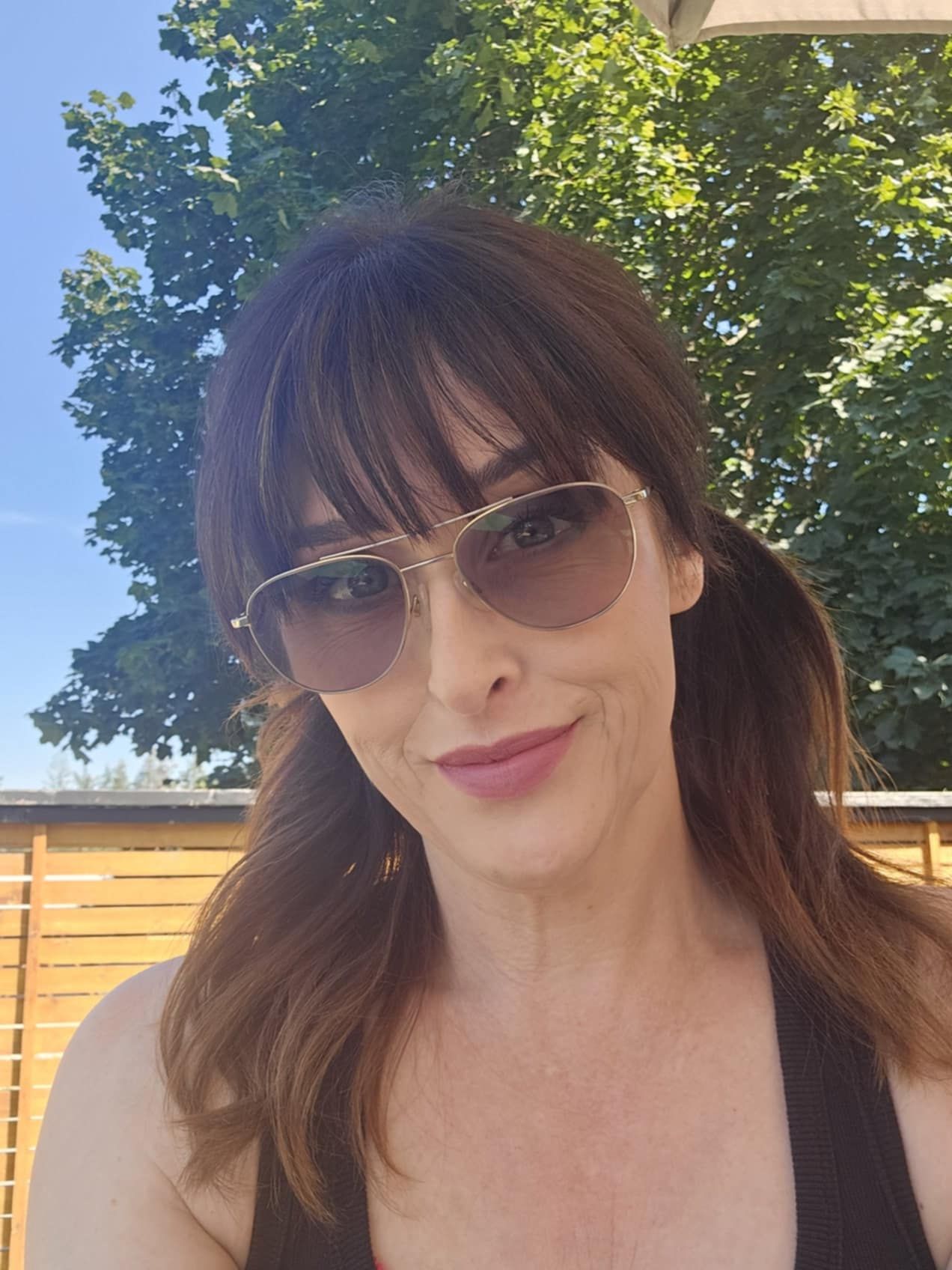 Outdoor selfie series showing summer style with sunglasses under bright sunlight.