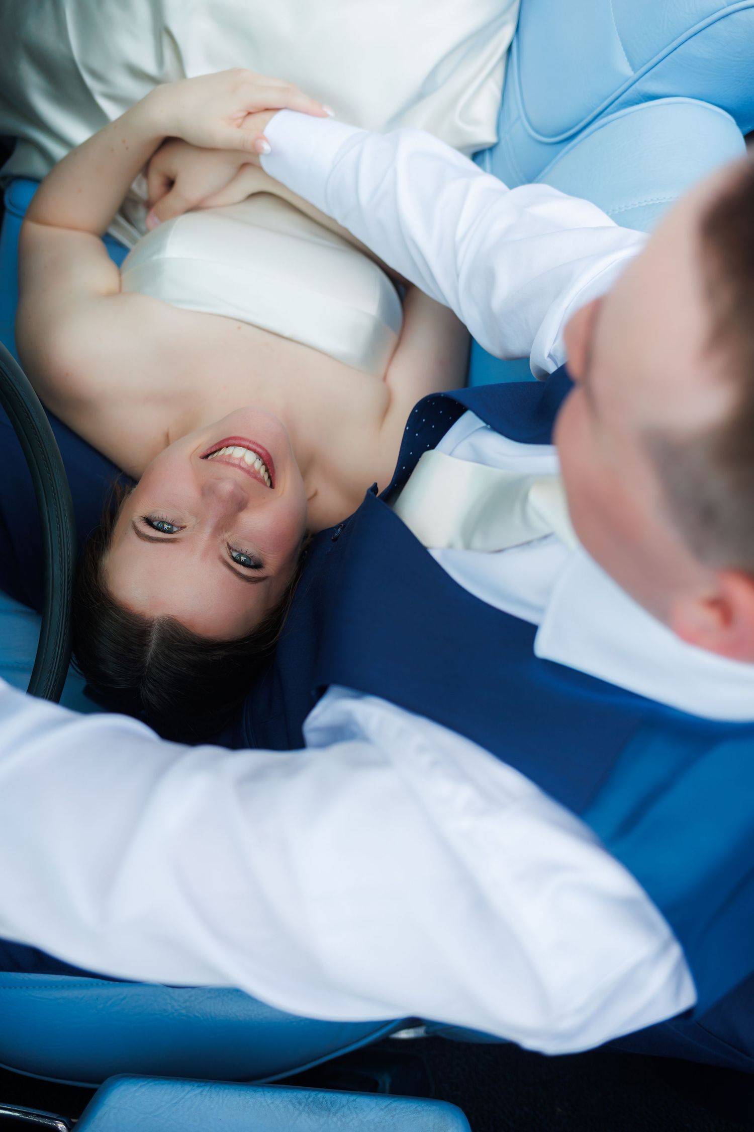 Professional dental hygienist at work examining patient in dentist chair.