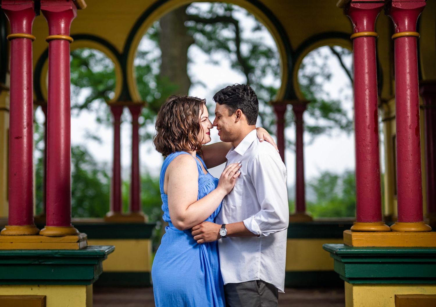 A couple shares romantic moments in a gazebo, captured in four different poses against red pillars and greenery background.