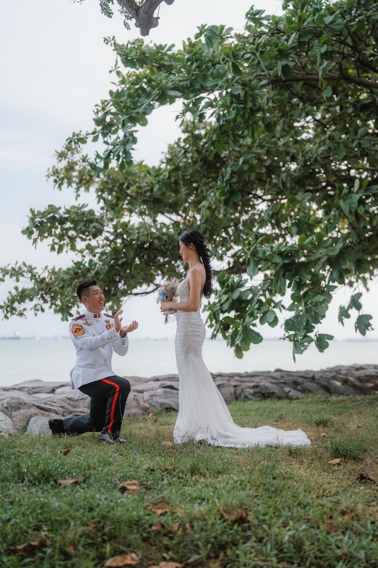 Playful wedding photo sequence shows couple dancing and twirling on grassy seaside terrain.