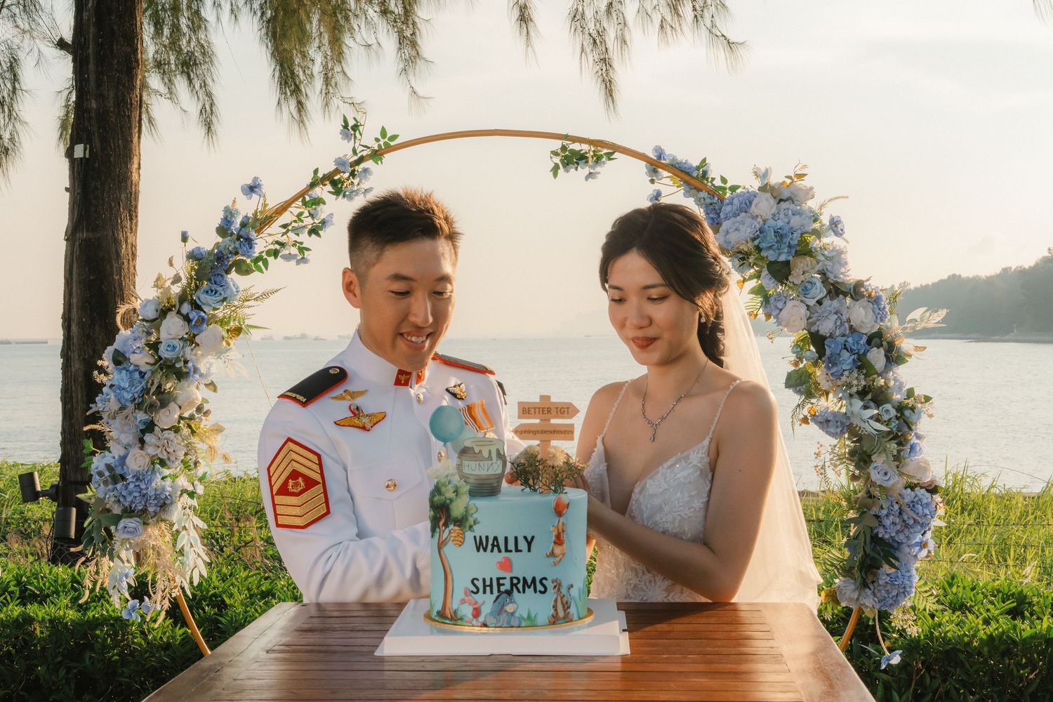 A laid-back outdoor celebration with cake and refreshments by the ocean during golden hour.