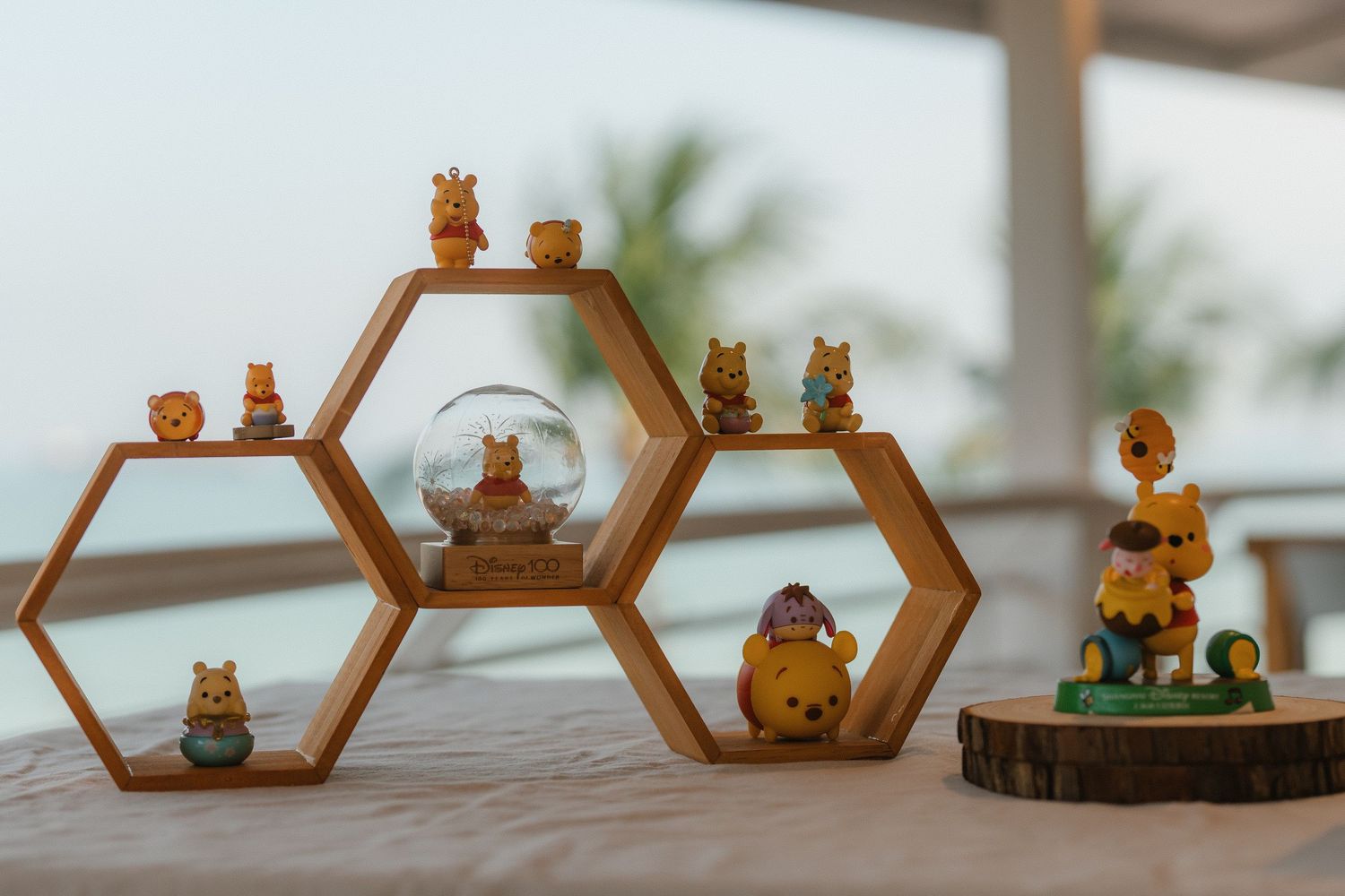 Wooden hexagonal shelves displaying adorable honey bear and bear-themed decorative figurines on a table.