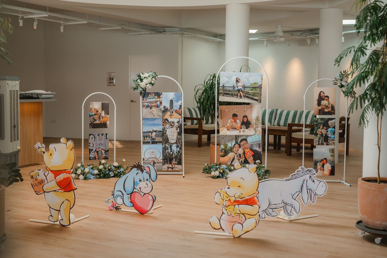 Whimsical Winnie the Pooh themed decorations displayed in a bright indoor event space.