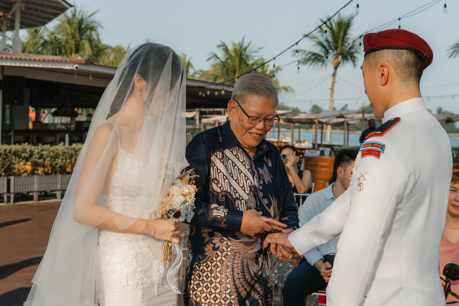 Wedding ceremony guests mingling and celebrating during outdoor reception at sunset.