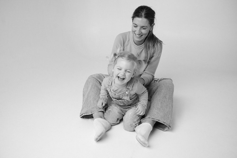 Black and white family portrait series showing candid moments of interaction