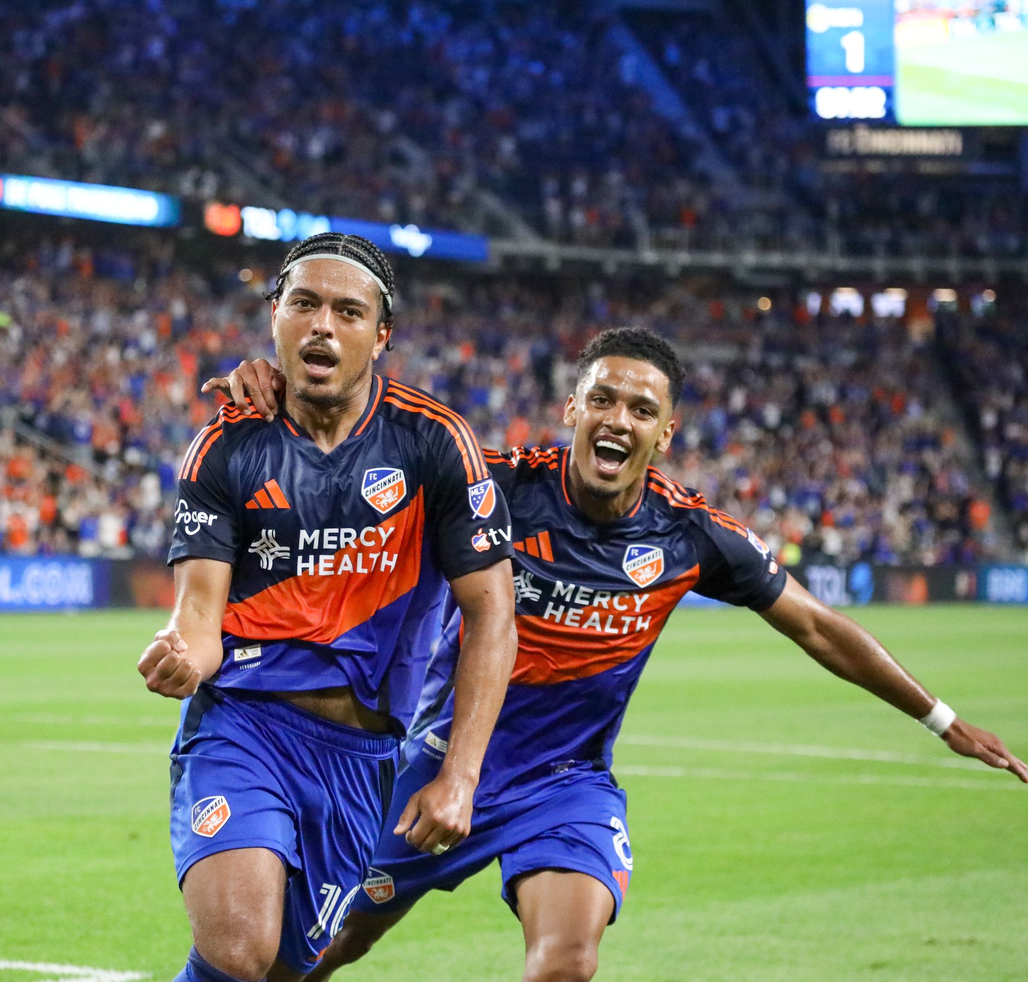 FC Cincinnati players celebrate during a soccer match with energetic reactions and emotional displays on the field.