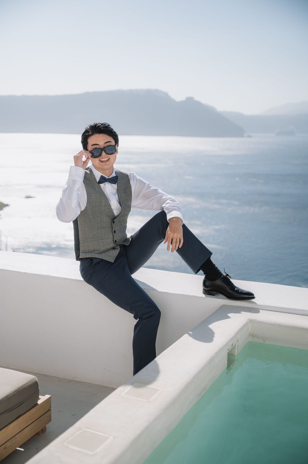 A stylish scene at a luxury infinity pool overlooking the Mediterranean coastline.