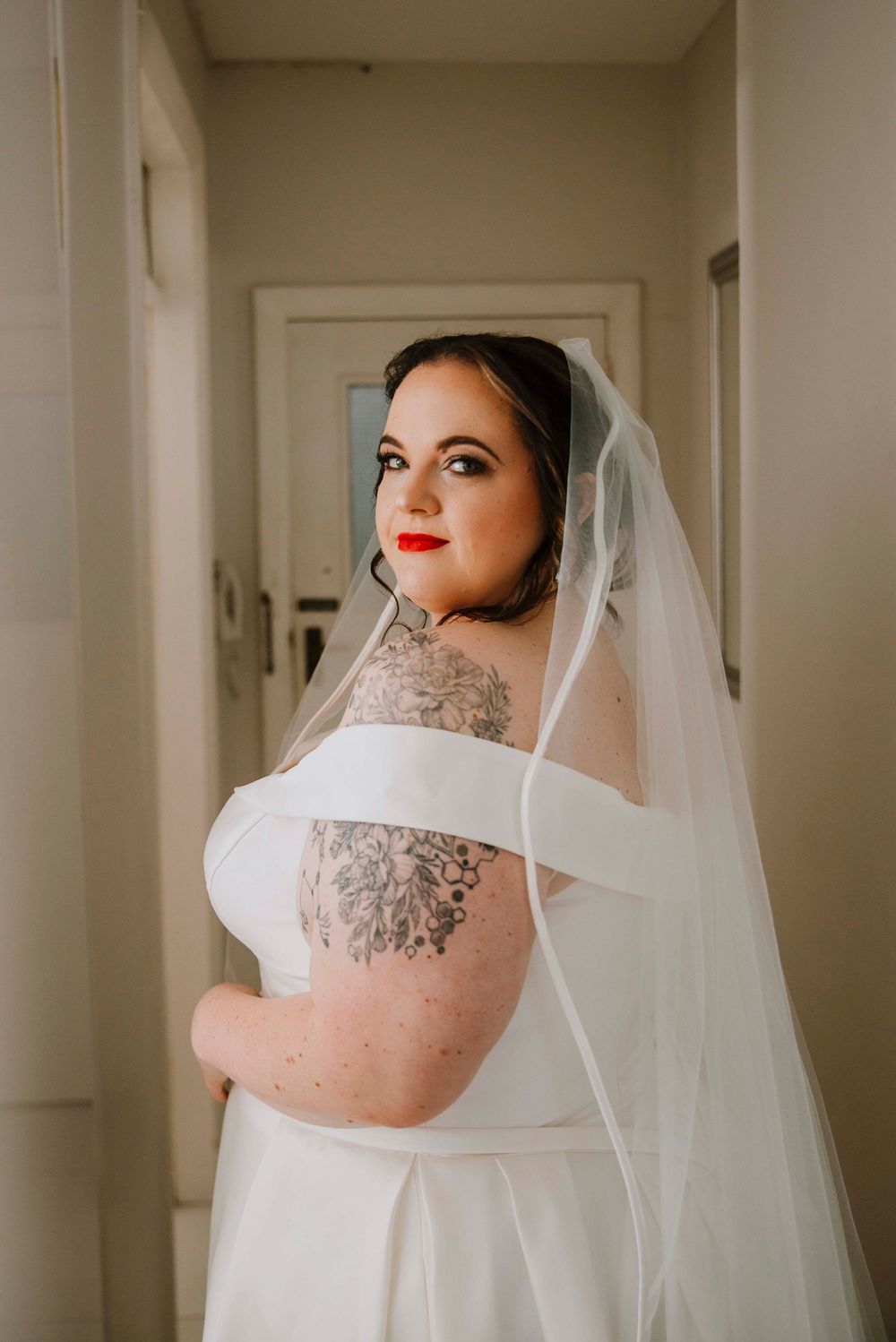 Elegant portrait of the bride looking over her shoulder during the getting ready photos.