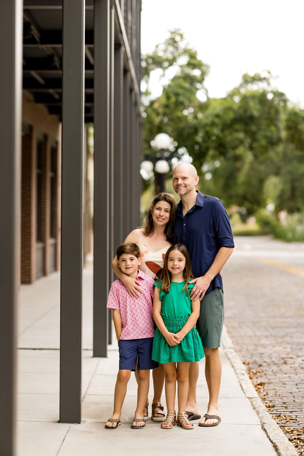 Family portrait under architectural columns with natural lighting. Photos by Tampa Photographer DigitalMyst Photography